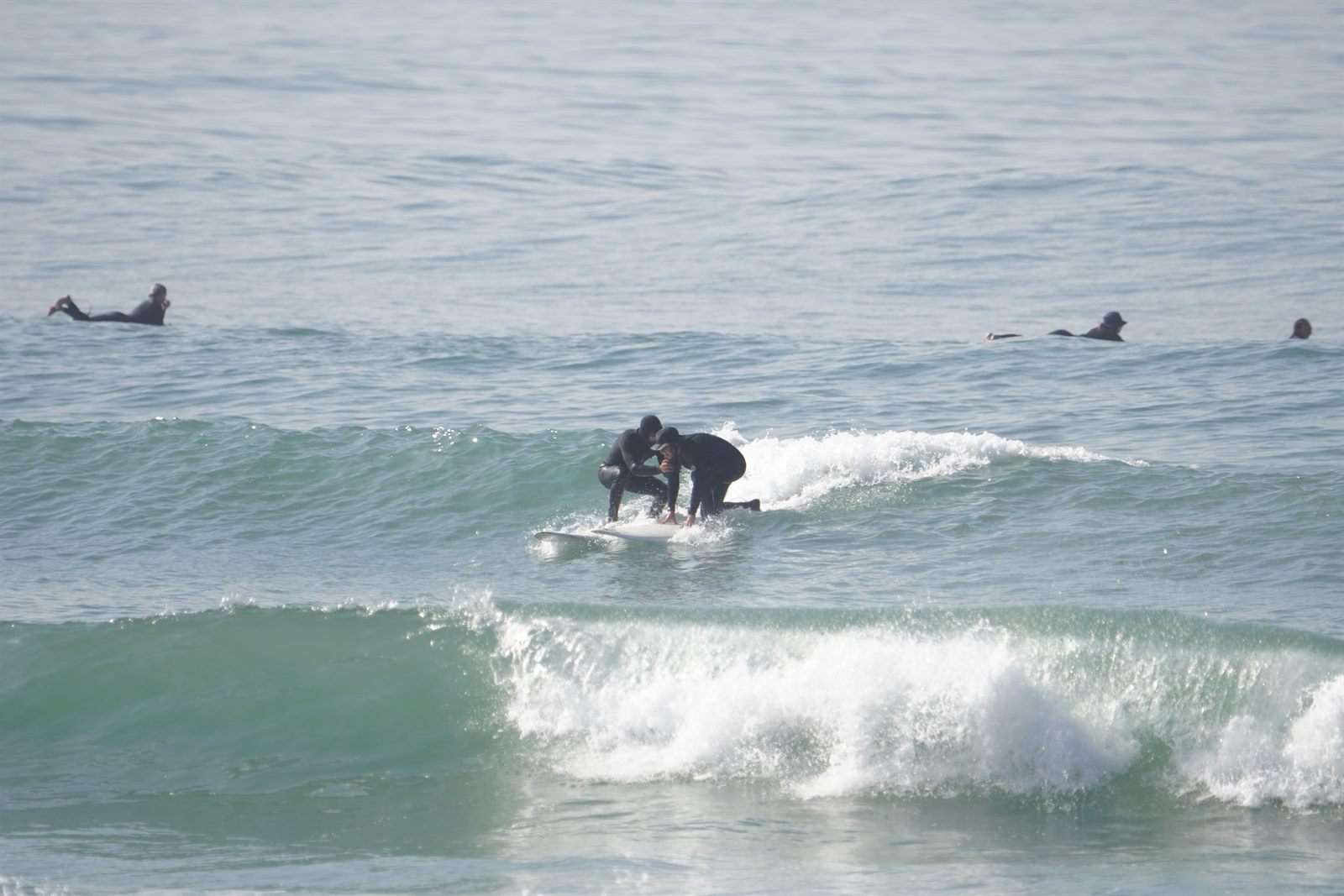 Small surf lesson group paddling out in Imsouane