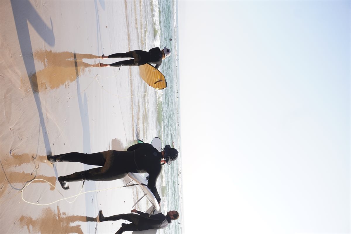 Surfers and boards on the beach in Imsouane